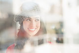 Portrait of a smiling brunette in grey hat