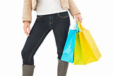 Mid section of woman holding shopping bags