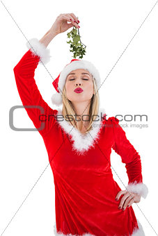 Festive blonde holding some mistletoe