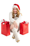 Smiling woman sitting on floor with shopping bag