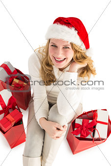 Smiling woman sitting on floor with shopping bag