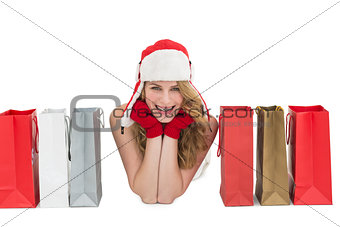 Smiling woman lying between shopping bags