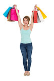 Excited blonde holding up shopping bags