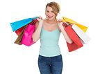 Cheerful blonde woman holding shopping bags