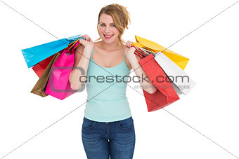Cheerful blonde woman holding shopping bags