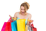 Excited woman looking at many shopping bags