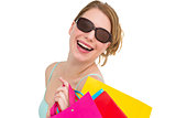 Portrait of a woman holding shopping bags wearing sunglasses