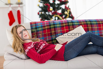 Day dreaming young woman lying on couch