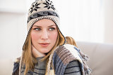 Beautiful blonde in winter hat thinking and looking away