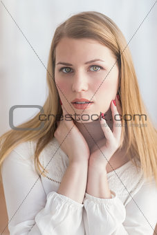 Portrait of a serious blonde woman looking at camera
