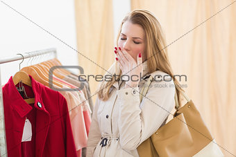 Pretty blonde woman tired during shopping