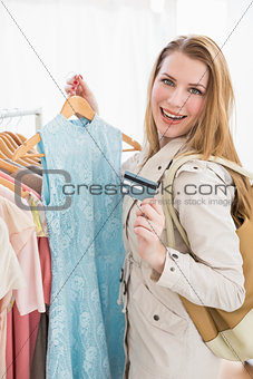 Pretty shopping blonde smiling at the camera