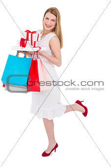 Elegant blonde with shopping bags and gifts
