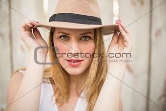 Close up of a blonde woman wearing hat