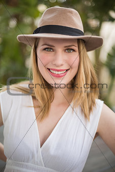 Portrait of a smiling blonde woman wearing hat