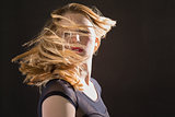 Pretty blonde woman tossing hair