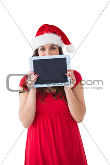Festive brunette showing a tablet