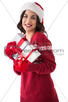 Cheerful brunette holding christmas presents