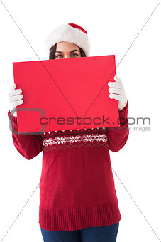 Brunette in winter clothes holding sign