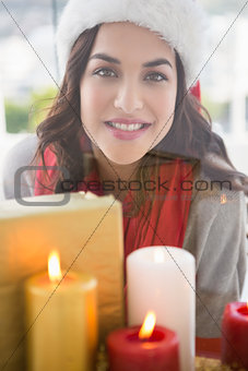 Portrait of pretty brunette behind candles