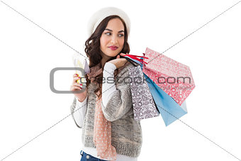 Brunette holding cash and shopping bags