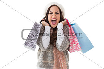 Excited brunette holding shopping bags