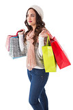 Brunette in winter clothes posing with shopping bags