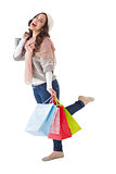 Excited brunette posing with shopping bag