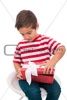 Cute little boy opening gift