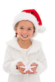 Festive little girl holding snowflake