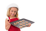 Festive little girl holding fresh cookies