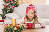 Cute little girl holding mug at Christmas