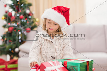 Cute little girl surrounded by christmas gifts