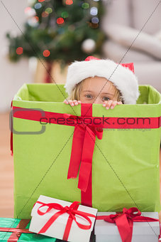 Cute little girl sitting in giant christmas gift
