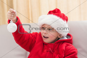Festive little boy holding a bauble