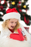 Festive little girl looking at gift