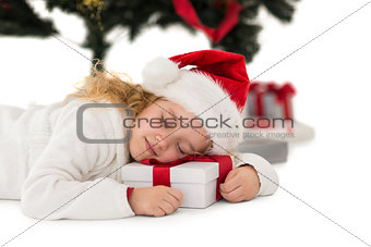 Festive little girl napping on a gift