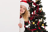 Festive little girl showing a poster