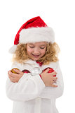 Festive little girl holding baubles