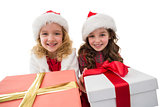 Festive little girls smiling at camera holding gifts