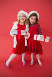 Festive little girls smiling at camera with gifts