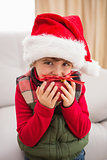 Festive little boy smiling at camera with bauble
