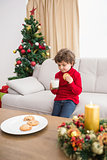 Festive little boy having milk and cookies