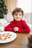 Festive little boy having milk and cookies