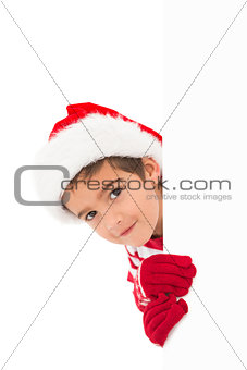 Festive little boy showing a card