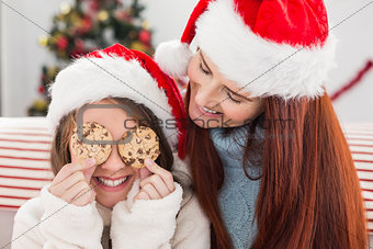 Festive mother and daughter on the couch with cookies
