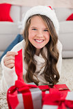 Festive little girl smiling at camera with gifts