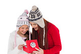 Mother and daughter opening christmas gift