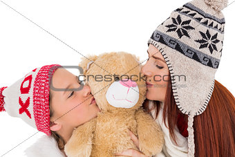 Mother and daughter holding teddy bear