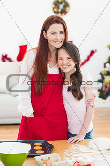 Festive mother and daughter baking together